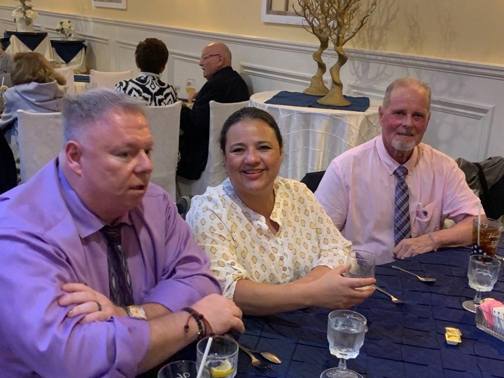 Members and guests at the Officer Installation dinner seated around a blue-clothed table