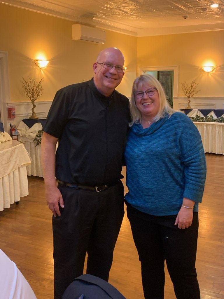 Two guests smiling together at the Officer Installation celebration