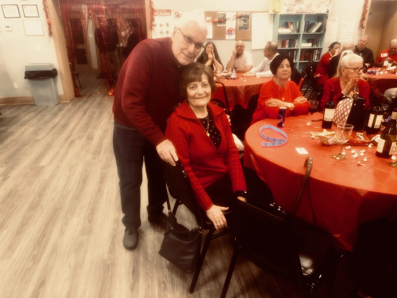 Guests smiling at a decorated table during the Valentine’s Day dinner and dance